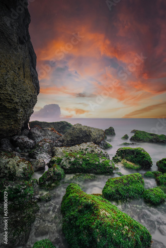 lanscape views of indrayanti beach yogyakarta gunungkidul indonesia cliffs and rocks on the seafront with beautiful clouds at sunrise or sunset