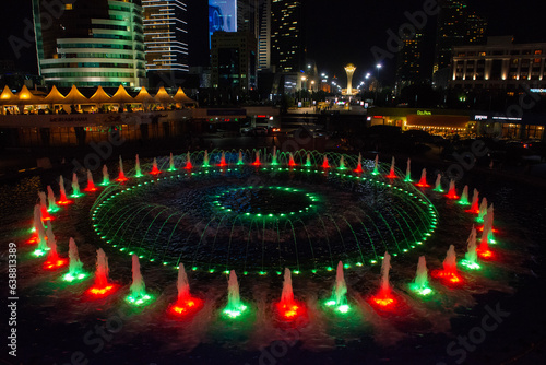 Astana, Kazakhstan 09.07.2018 : fountain show at night in the center of Astana, Kazakhstan. in the background, the Bayterek Tower is a monument and an observation deck