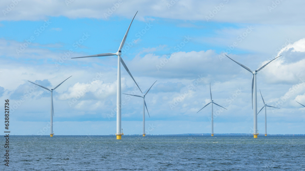 windmill park in the ocean aerial view with wind turbine Flevoland Netherlands Ijsselmeer. Green energy 