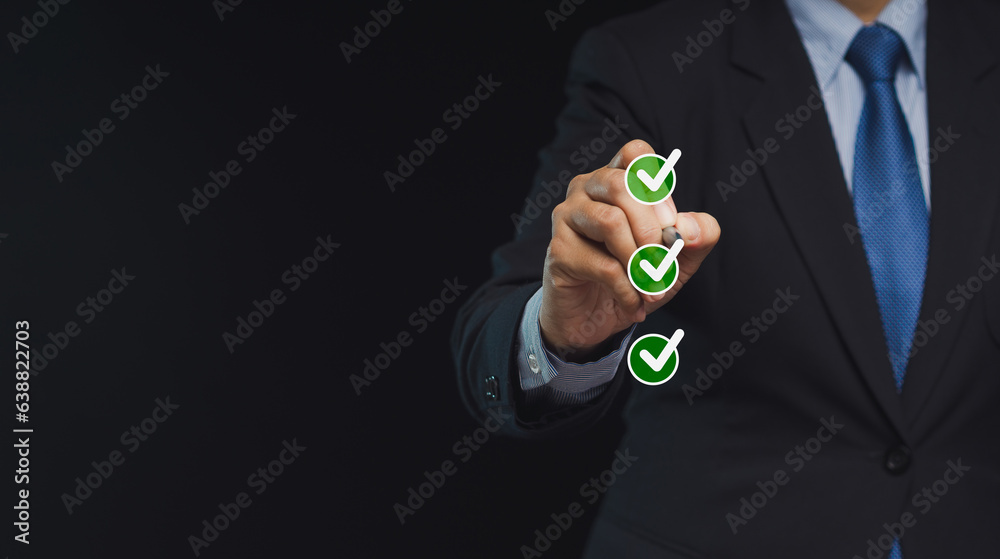 Fototapeta premium Businessman uses a pen to tick the correct sign in the checkbox for the quality document control checklist