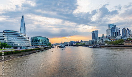 Panoramic view of the skyline of London city from the Tower Bridge at sunset time, United Kingdom. View of Thames river and both North and South banks of the famous City of London