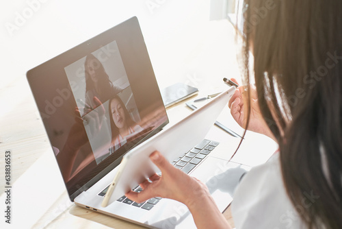 Asian doctor using tablet during online consultation with patien