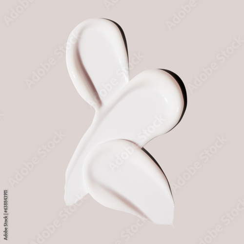 Tableau sur toile cosmetic product smears of cream on beige background, lotion white smudge, moist