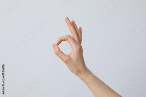 Female hand shows OK gesture. OK hand sign