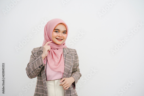 Studio portrait of beautiful young muslim businesswoman pink hijab smiling at camera on white background.