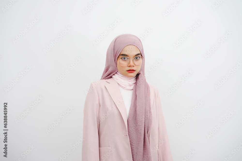 Studio portrait of beautiful young muslim businesswoman pink hijab in eyeglasses posing and looking at the camera over white background. Studio portrait of beautiful young muslim businesswoman pink hijab in eyeglasses posing and looking at the camera over white background.
