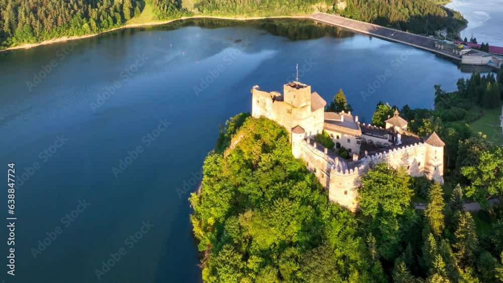 Poland. Medieval castle in Niedzica in sunset light. Artificial Czorsztyn lake on Dunajec river, damn and hydro power station. Aerial panning video from above Poland. Medieval castle in Niedzica in sunset light. Artificial Czorsztyn lake on Dunajec river, damn and hydro power station. Aerial panning video from above