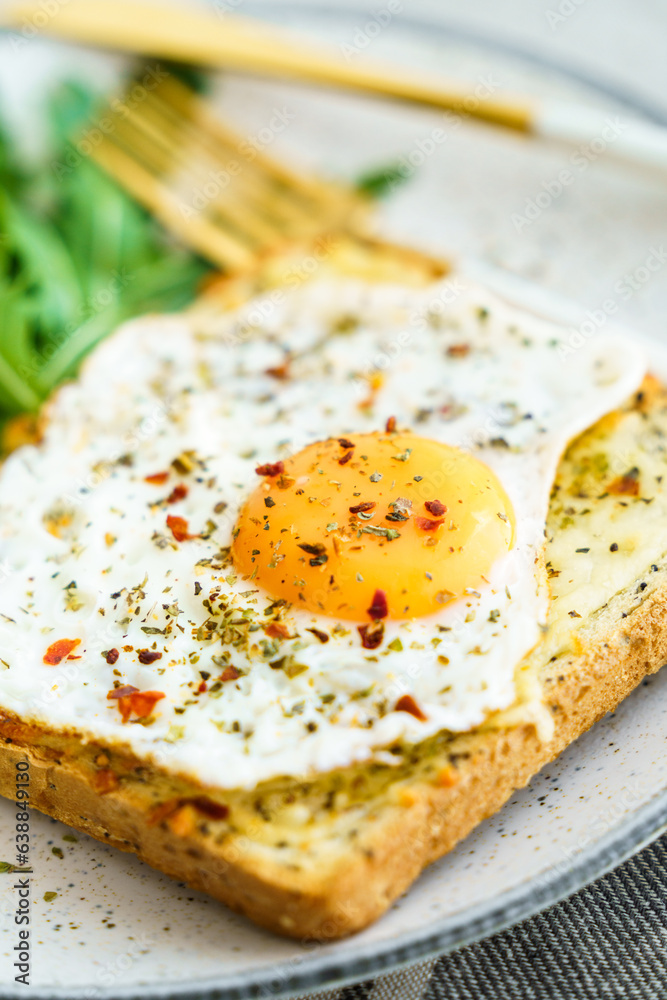 Delicious breakfast of fried eggs with toast and salad.