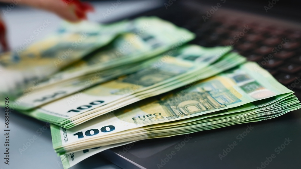 A woman counts expenses on a laptop, calculates finances and expects to make purchases. Concept of a business woman behind a laptop. A woman counts expenses on a laptop, calculates finances and expects to make purchases. Concept of a business woman behind a laptop.