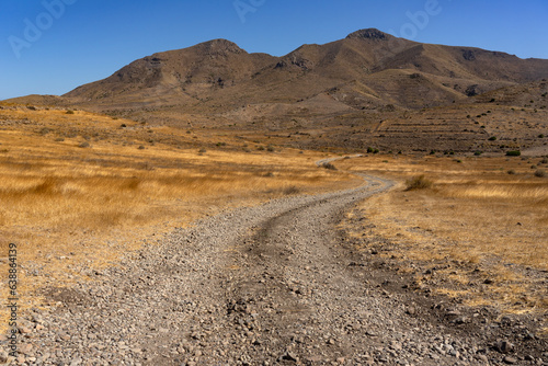 Panoramic view of of mountains with a dirt road in the Gata Cape Natural Park coast. Almería, Andalucía, Spain.