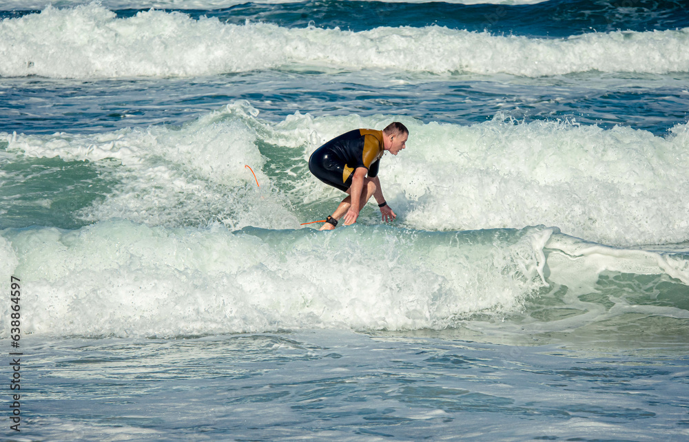 Middle-aged man surfing on the waves of the atlantic ocean Middle-aged man surfing on the waves of the atlantic ocean