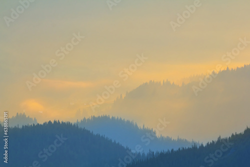 mountain ridge silhouette in blue mist, early morning mountain background
