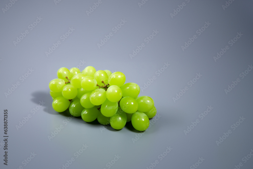 Grapes green fruit on a solid color background. Isolated object in photo studio. Commercial shot with copyspace. Grapes green fruit on a solid color background. Isolated object in photo studio. Commercial shot with copyspace.