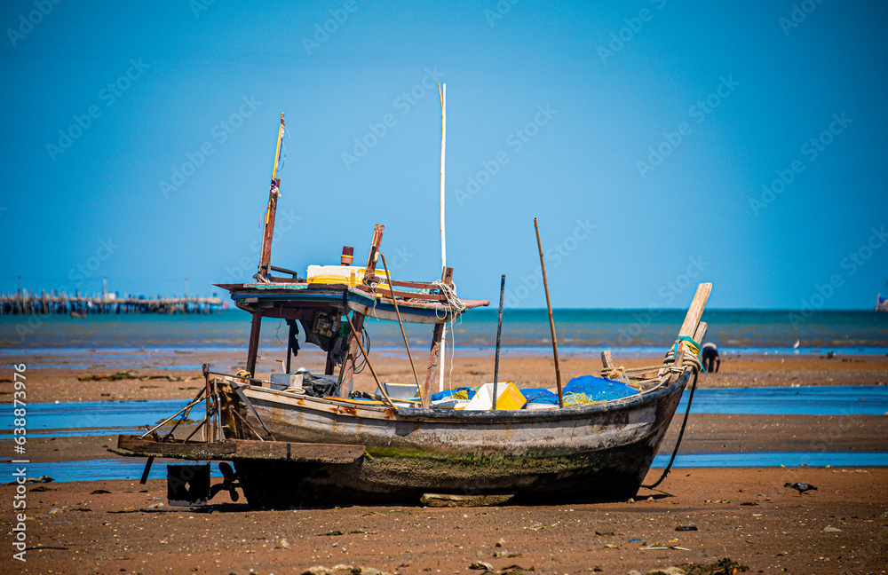Local fishing boats run aground during low tide in front of Ban Na Kluea Bay, Chon Buri Province, Thailand, 18 August 2023.