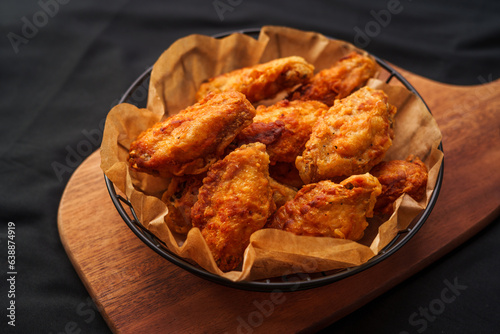 Crispy fried chicken wings on a chopping board