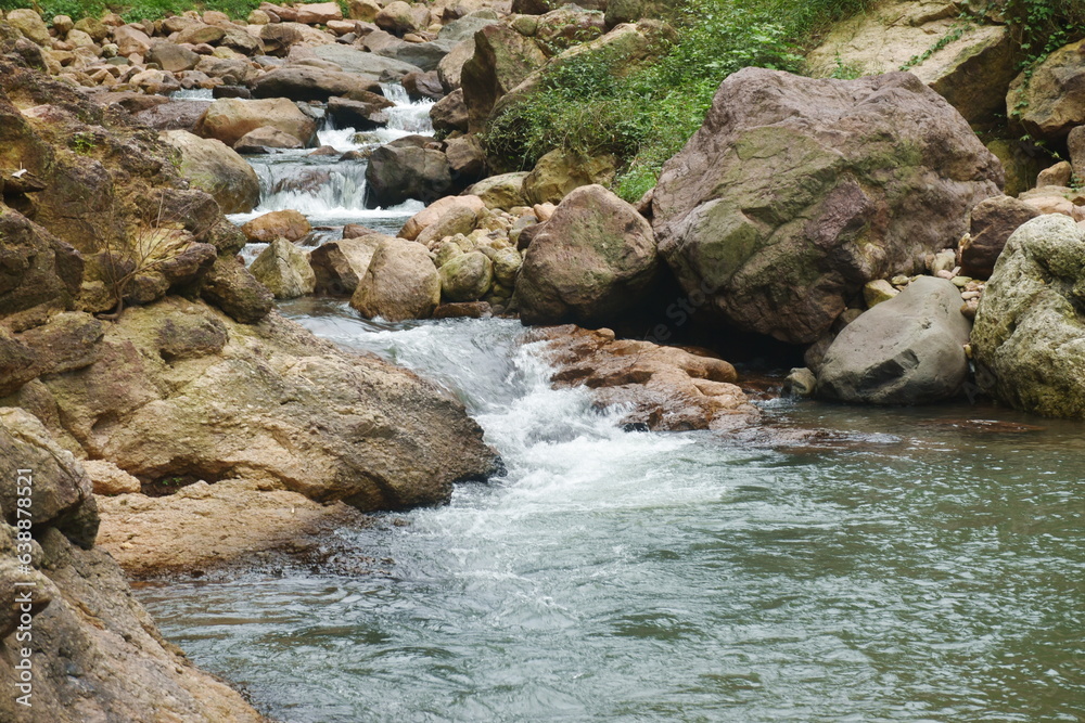 water falling on river pass rock and stone at Kho Chong Lom waterfall in Thailand water falling on river pass rock and stone at Kho Chong Lom waterfall in Thailand