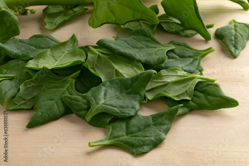 Fresh raw New Zealand spinach leaves on a cutting board close up