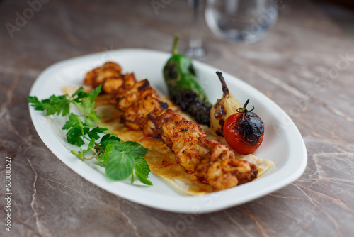 Delicious grilled skewer chicken with vegetables on a plate