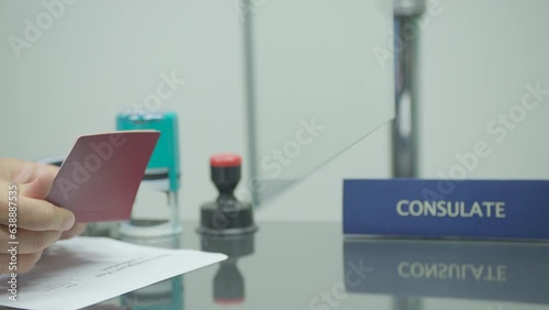 State officer checking passport and documents at consulate center photo