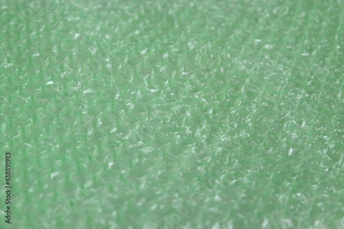 Green bubble plastic wrap air filled transparent packaging for protection.narrow focus.