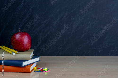 Colorful school supplies on wooden desk