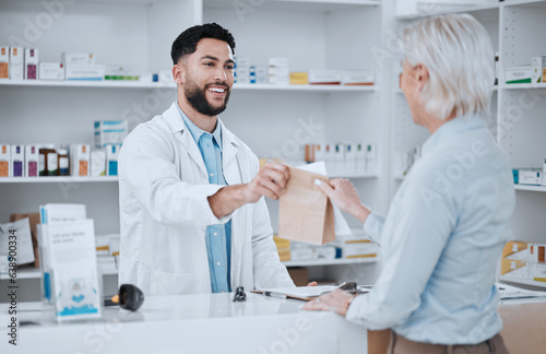 Happy man, pharmacist and paper bag for customer in consultation, medication or pills at pharmacy. Male person, medical or healthcare employee giving patient pharmaceutical products at drugstore