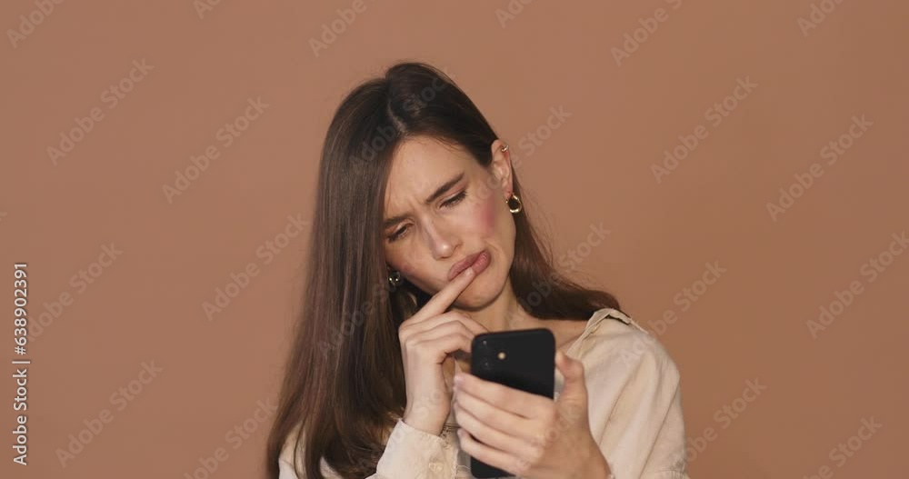 Need to think! Pensive doubting woman in shirt pondering and imagining in mind, wondering difficult solution, feeling confused, not sure about choice, hold mobile phone. Yes, not bad. Need to think! Pensive doubting woman in shirt pondering and imagining in mind, wondering difficult solution, feeling confused, not sure about choice, hold mobile phone. Yes, not bad.
