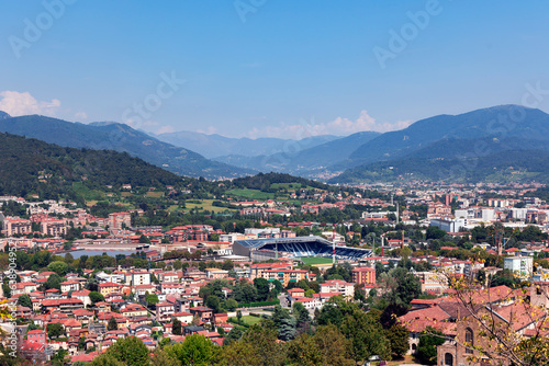 Aerial view of the old town Bergamo in northern Italy with red tiled roofs of houses on the background of the Alpine mountains. Bergamo is a city in the alpine Lombardy region.