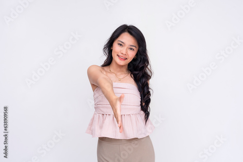 A friendly young asian woman offers a handshake. A lady befriending someone. Isolated on a white background. © Mdv Edwards