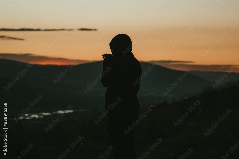 Photo of silhouette of a man in a dramatic sunset in the mountains of Peru. Concept of travel, nature and people.