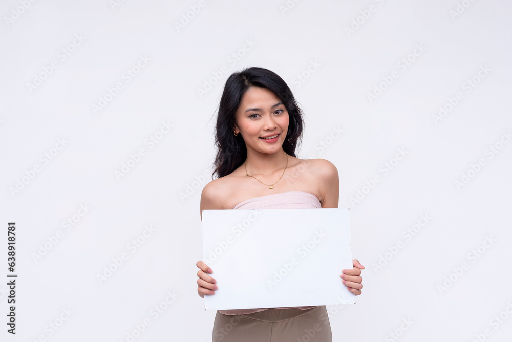 A smart young Asian woman smiling pleasantly while holding a white blank signange. Isolated on a white background. A smart young Asian woman smiling pleasantly while holding a white blank signange. Isolated on a white background.