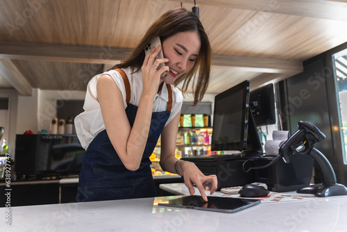 Happy Asian Young Woman Checking Customer Orders on Mobile Phone