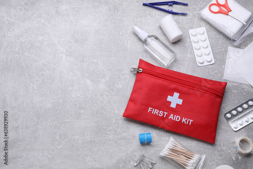 Flat lay composition with first aid kit on light gray background, space for text