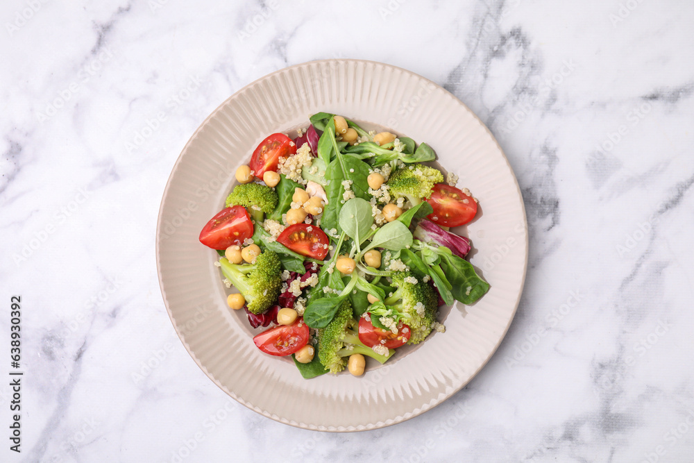 Healthy meal. Tasty salad with quinoa, chickpeas and vegetables on white marble table, top view