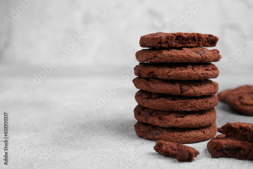Tasty chocolate cookies on light grey table, closeup. Space for text