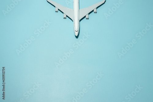 Wallpaper Mural A plane miniature and isolated on blue background, after some edits. Torontodigital.ca