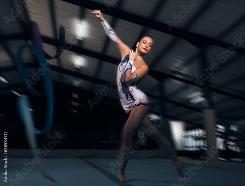 Fitness, performance and motion blur with a dance woman in a gym for training or practice for a competition. Exercise, event and energy with a young gymnastic or rhythmic dancer in a workout studio