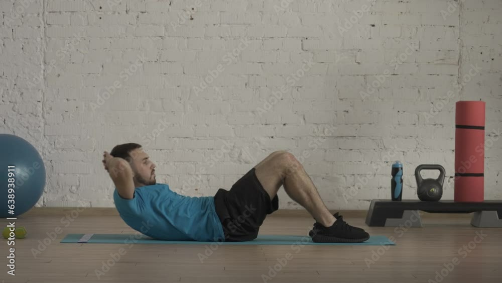 Closeup shot. Man fitness coach in sportswear doing classic abs crunches exercise for online class at the home studio. HDR BT2020 HLG Material. Closeup shot. Man fitness coach in sportswear doing classic abs crunches exercise for online class at the home studio. HDR BT2020 HLG Material.