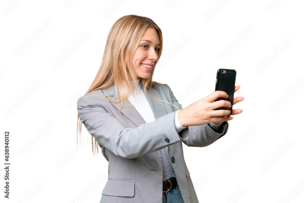 Young pretty blonde woman over isolated chroma key background making a selfie Young pretty blonde woman over isolated chroma key background making a selfie