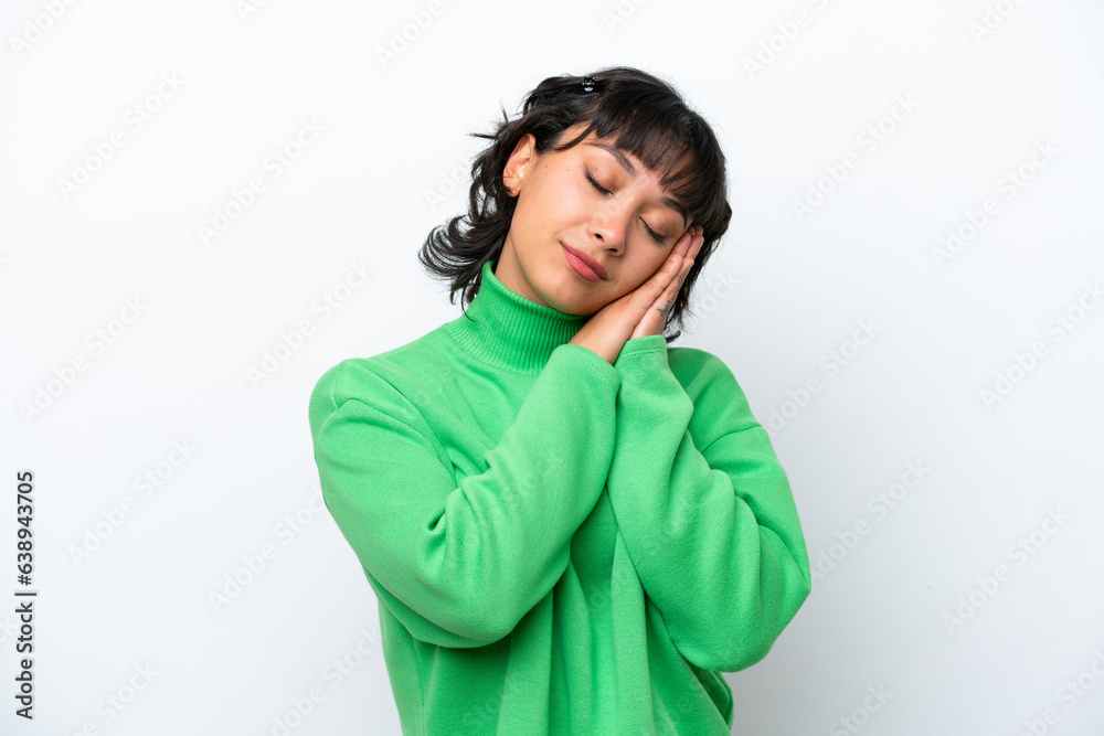 Young Argentinian woman isolated on white background making sleep gesture in dorable expression Young Argentinian woman isolated on white background making sleep gesture in dorable expression