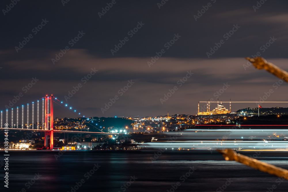 View of Camlica Mosque and Bosphorus Bridge. colored lines formed by the lights of the moving steamers. A beautiful night view of the Bosphorus. Istanbul Türkiye
