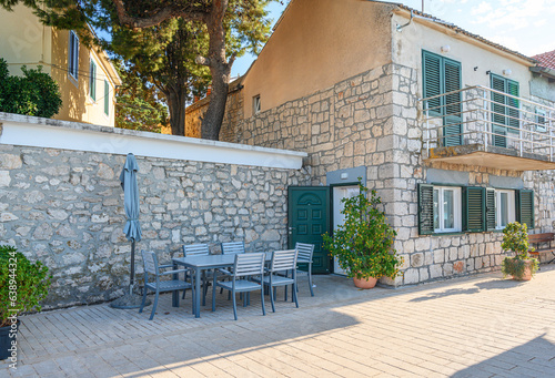 Fototapeta Naklejka Na Ścianę i Meble -  Table and chairs on the terrace of a house in the Adriatic region.