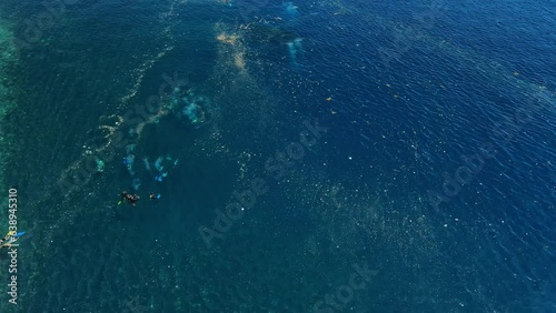 Swimming and diving in plastic pollution at Liberty wreck ship in Tulamben, Bali. Tourism and ecological problems photo