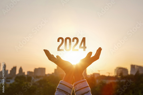 2024 is supported by woman hands.