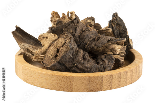 dried udu hindi root in a wooden bowl photo