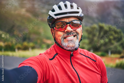 Happy man, cyclist and portrait in selfie on mountain bicycle for photograph, picture or outdoor memory in nature. Male person or athlete smile in photo, happiness or cycling in fitness or travel © LuneVA/peopleimages.com