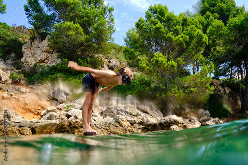 Unrecognizable boy diving into water