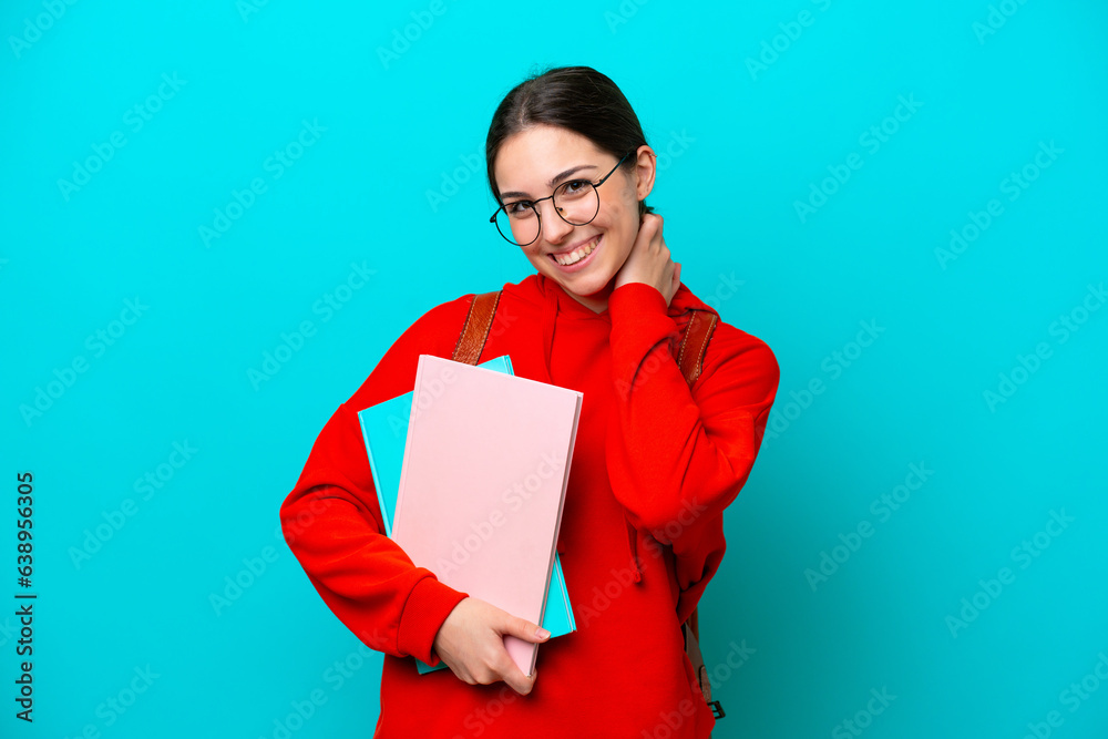 Young student caucasian woman isolated on blue background laughing Young student caucasian woman isolated on blue background laughing