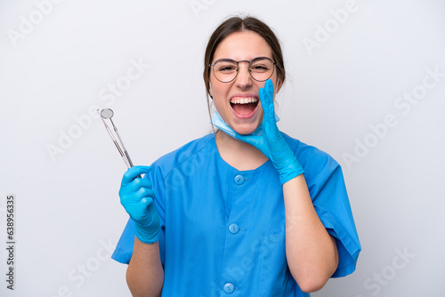 Dentist caucasian woman holding tools isolated on white background shouting with mouth wide open
