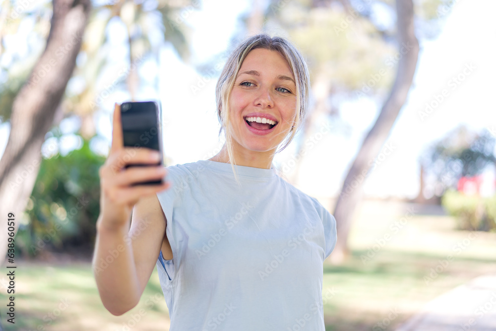 Young blonde woman at outdoors making a selfie Young blonde woman at outdoors making a selfie